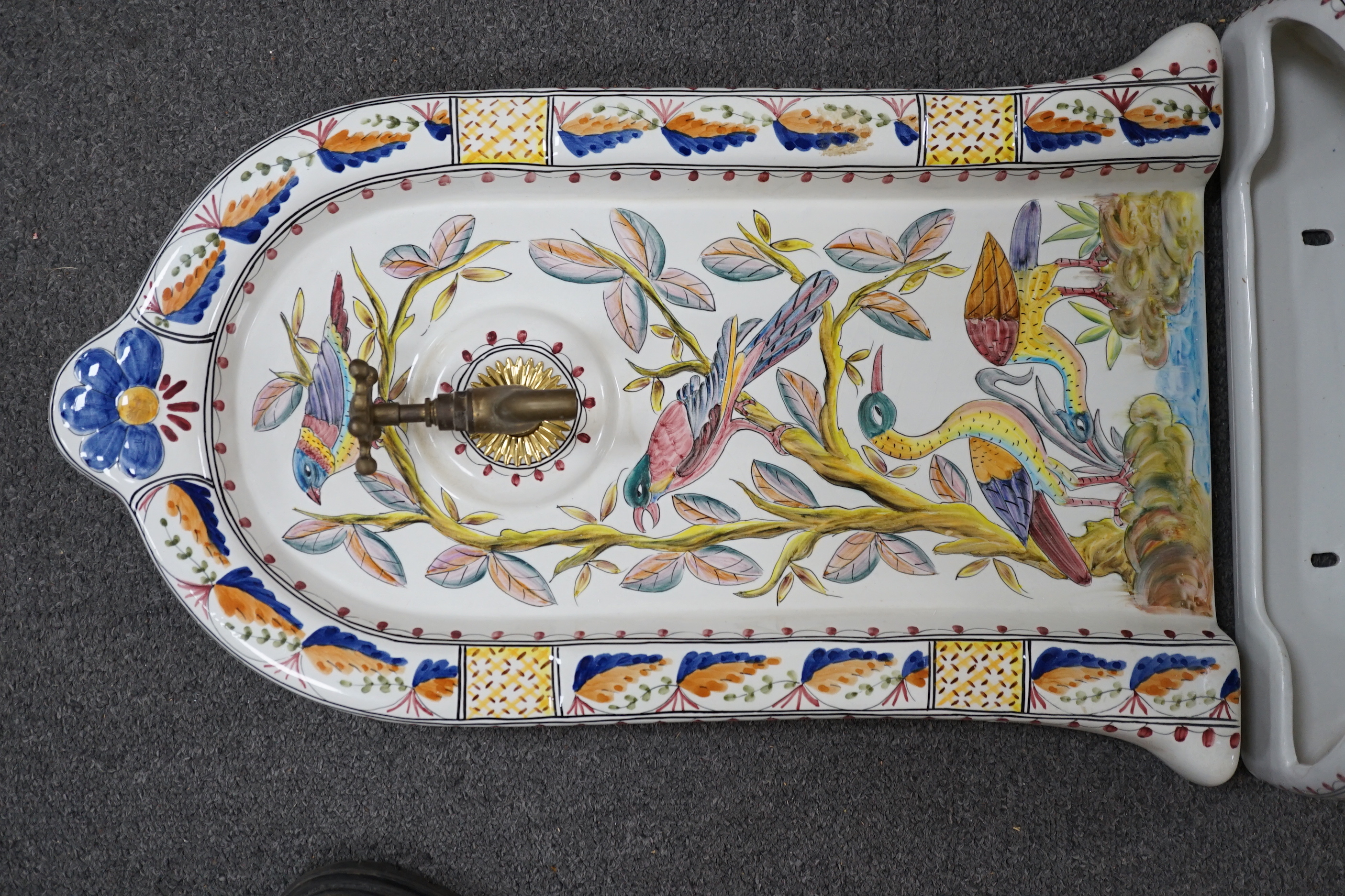 A Portuguese pottery font and basin, hand painted with birds and flowers, 66cm high